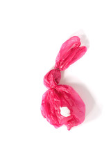 Red rabbit made of plastic bag on the isolated white background. The symbol out of waste and suffering wild animals.