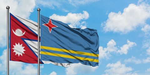 Nepal and Aruba flag waving in the wind against white cloudy blue sky together. Diplomacy concept, international relations.