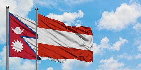 Nepal and Austria flag waving in the wind against white cloudy blue sky together. Diplomacy concept, international relations.