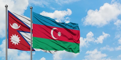 Nepal and Azerbaijan flag waving in the wind against white cloudy blue sky together. Diplomacy concept, international relations.