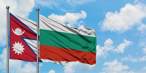 Nepal and Bulgaria flag waving in the wind against white cloudy blue sky together. Diplomacy concept, international relations.