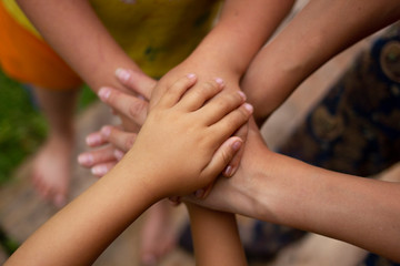 Four hands of the family, a baby, a daughter, a mother and a father. Concept of unity, support, protection and happiness. Family. Hands of Mother father and kids close up. Family hands