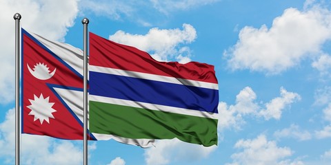 Nepal and Gambia flag waving in the wind against white cloudy blue sky together. Diplomacy concept, international relations.