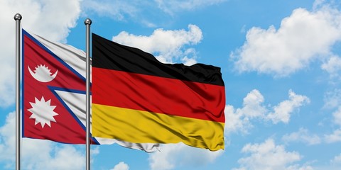 Nepal and Germany flag waving in the wind against white cloudy blue sky together. Diplomacy concept, international relations.