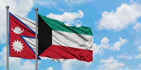 Nepal and Kuwait flag waving in the wind against white cloudy blue sky together. Diplomacy concept, international relations.