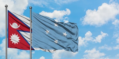 Nepal and Micronesia flag waving in the wind against white cloudy blue sky together. Diplomacy concept, international relations.
