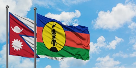 Nepal and New Caledonia flag waving in the wind against white cloudy blue sky together. Diplomacy concept, international relations.