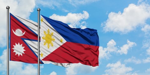 Nepal and Philippines flag waving in the wind against white cloudy blue sky together. Diplomacy concept, international relations.