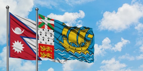 Nepal and Saint Pierre And Miquelon flag waving in the wind against white cloudy blue sky together. Diplomacy concept, international relations.