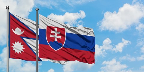 Nepal and Slovakia flag waving in the wind against white cloudy blue sky together. Diplomacy concept, international relations.