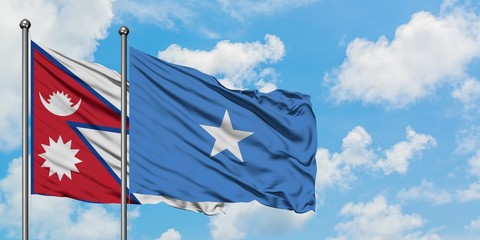Nepal and Somalia flag waving in the wind against white cloudy blue sky together. Diplomacy concept, international relations.