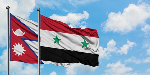 Nepal and Syria flag waving in the wind against white cloudy blue sky together. Diplomacy concept, international relations.