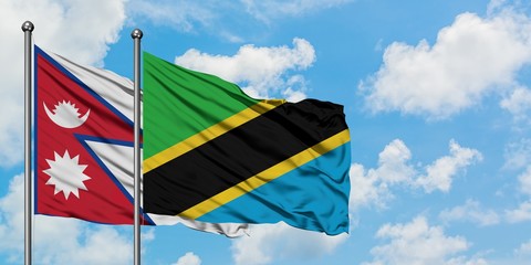 Nepal and Tanzania flag waving in the wind against white cloudy blue sky together. Diplomacy concept, international relations.