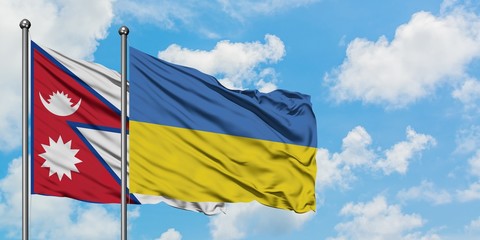 Nepal and Ukraine flag waving in the wind against white cloudy blue sky together. Diplomacy concept, international relations.