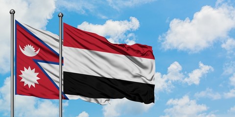 Nepal and Yemen flag waving in the wind against white cloudy blue sky together. Diplomacy concept, international relations.