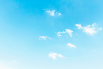 Naklejka na ściany i meble Fluffy white clouds flying on blue sky background