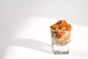 ์Natural Rock Sugar on Cocktail glass isolate on white background.