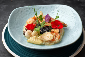 Seafood risotto on a dark background