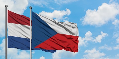Netherlands and Czech Republic flag waving in the wind against white cloudy blue sky together. Diplomacy concept, international relations.