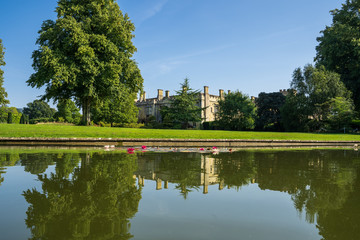 Castle surrounded by a garden with a lake