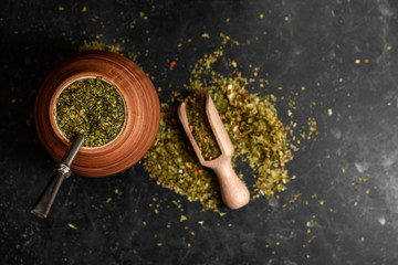 Beautiful composition of yerba mate on a black background - Juicy and green leaves without sticks