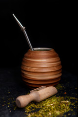Beautiful composition of yerba mate on a black background - Juicy and green leaves without sticks
