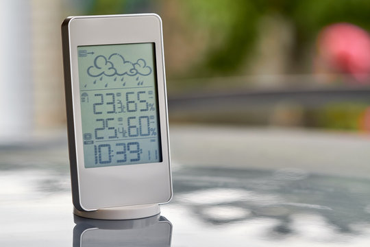 Best personal weather station device with weather conditions inside and outside. Home digital weather forecast concept with temperature and humidity.