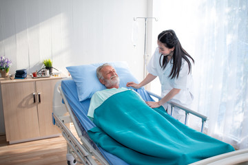 Doctor or Nurse help or assist or take care old patient in the hospital, elder care consulting or...