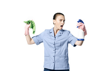Fototapeta na wymiar A beautiful young woman in the uniform of a maid holds a rag and spray for washing windows and looks at them in surprise. Isolated on a white background.
