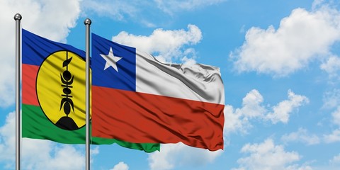 New Caledonia and Chile flag waving in the wind against white cloudy blue sky together. Diplomacy concept, international relations.