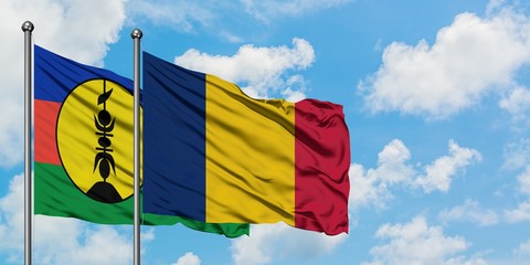 New Caledonia and Chad flag waving in the wind against white cloudy blue sky together. Diplomacy concept, international relations.