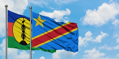 New Caledonia and Congo flag waving in the wind against white cloudy blue sky together. Diplomacy concept, international relations.