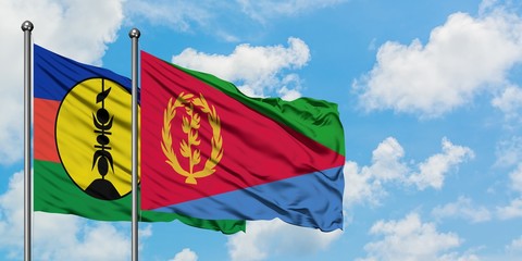 New Caledonia and Eritrea flag waving in the wind against white cloudy blue sky together. Diplomacy concept, international relations.