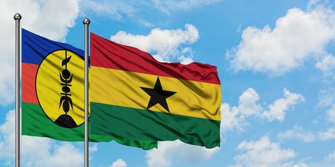 New Caledonia and Ghana flag waving in the wind against white cloudy blue sky together. Diplomacy concept, international relations.