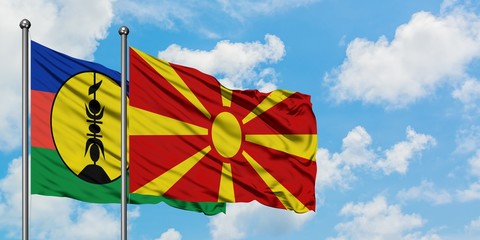 New Caledonia and Macedonia flag waving in the wind against white cloudy blue sky together. Diplomacy concept, international relations.