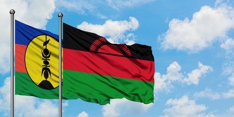 New Caledonia and Malawi flag waving in the wind against white cloudy blue sky together. Diplomacy concept, international relations.