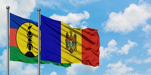 New Caledonia and Moldova flag waving in the wind against white cloudy blue sky together. Diplomacy concept, international relations.