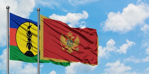 New Caledonia and Montenegro flag waving in the wind against white cloudy blue sky together. Diplomacy concept, international relations.