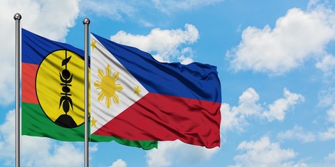 New Caledonia and Philippines flag waving in the wind against white cloudy blue sky together. Diplomacy concept, international relations.