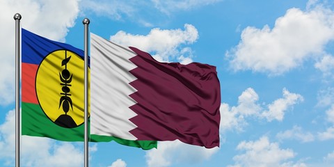 New Caledonia and Qatar flag waving in the wind against white cloudy blue sky together. Diplomacy concept, international relations.