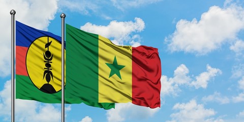 New Caledonia and Senegal flag waving in the wind against white cloudy blue sky together. Diplomacy concept, international relations.