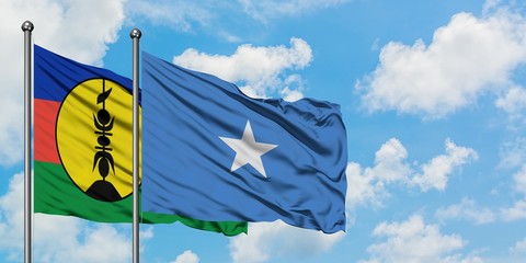 New Caledonia and Somalia flag waving in the wind against white cloudy blue sky together. Diplomacy concept, international relations.