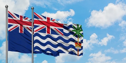 Fototapeta na wymiar New Zealand and British Indian Ocean Territory flag waving in the wind against white cloudy blue sky together. Diplomacy concept, international relations.