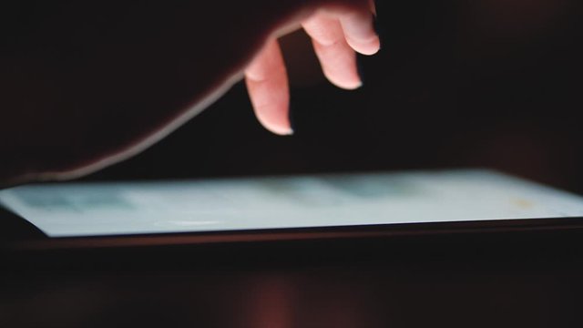 Woman using smartphone for shopping online at night close-up. Girl hands tapping on phone touchscreen at night time