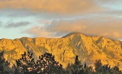 Golden mountains lit by the evening sunset sun