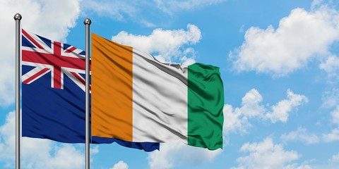 New Zealand and Cote D'Ivoire flag waving in the wind against white cloudy blue sky together. Diplomacy concept, international relations.