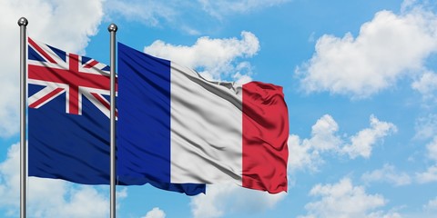 New Zealand and France flag waving in the wind against white cloudy blue sky together. Diplomacy concept, international relations.