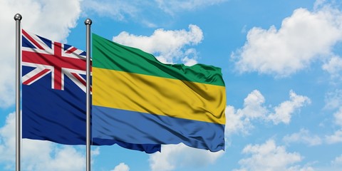 New Zealand and Gabon flag waving in the wind against white cloudy blue sky together. Diplomacy concept, international relations.