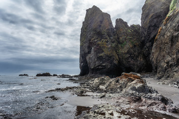 Fototapeta premium Picturesque seascape of Kamchatka: scenery rocky islands in sea with waves