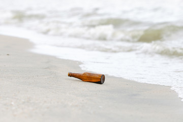 A glass bottle on the beach.Trash on the beach 